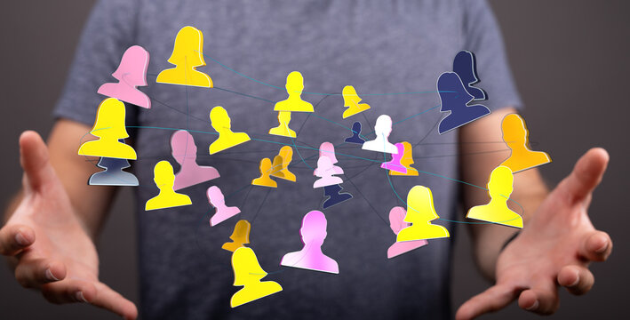 Concept of digital networking and people connecting. Hand holding people icons. Teamwork, communication, technology, global network concept.