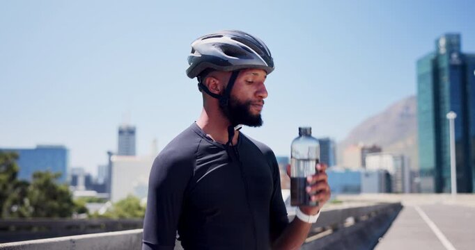 Drinking water, helmet and black man with fitness, outdoor and hydration with practice. African person, nutrition and cyclist in city, bottle or thirsty with aqua, minerals and healthy with detox - Powered by Adobe