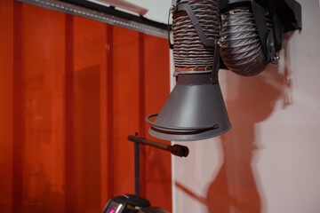 Industrial workspace featuring ventilation system with orange backdrop creating a unique aesthetic