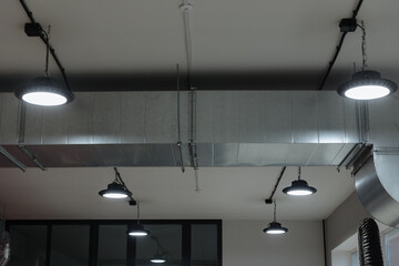 Unique industrial lighting designs in a modern interior space with sleek accents