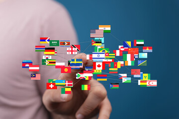 A digital hand interacting with a network of country flags illustrating global connections, travel, and international relations. Concepts of glo