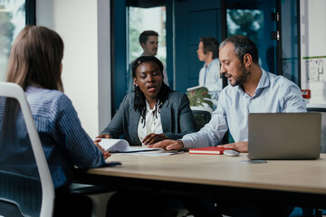 Black Female Manager Leading Feedback Session in Office