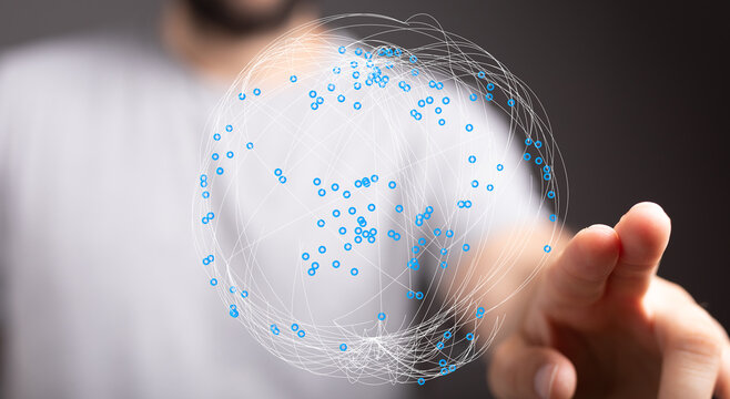 Concept of global network and digital connections. Man pointing at a globe with connections around it. Ideal for technology, communic