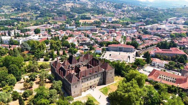 Cinematic Aerial View of Guimaraes, Portugal &mdash; Historic Medieval City, Castle, Stone Streets and Scenic Urban Landscape from Drone