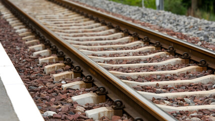 Railroad tracks stretching into the distance create a sense of journey and adventure for travel campaigns