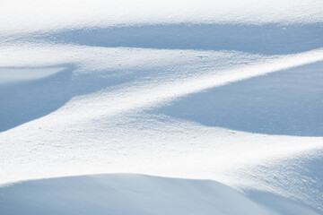 Light and shadow zigzag shape in fresh white winter snow