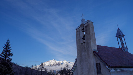 Notre-Dame de Bois vert chapel with snowy mountains