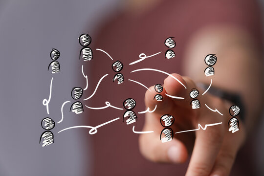 Abstract visual of a hand interacting with a digital network of interconnected user icons, symbolizing modern communication, teamwork, and busin