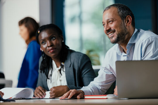 Diverse Business Colleagues Discussing Project in Modern Open Plan Office