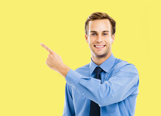Portrait image - happy smile confident business man wear blue shirt, tie point showing pointing...