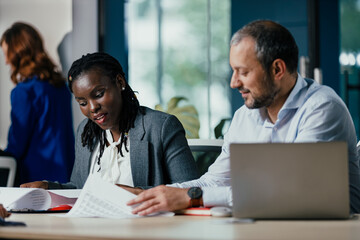 Smiling Black Woman Leading Feedback Session Meeting in Modern Open Office