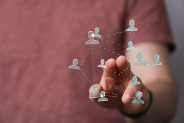 Hand interacting with digital network of people. Represents connection, communication, social media, teamwork, and business strategy. Concept of