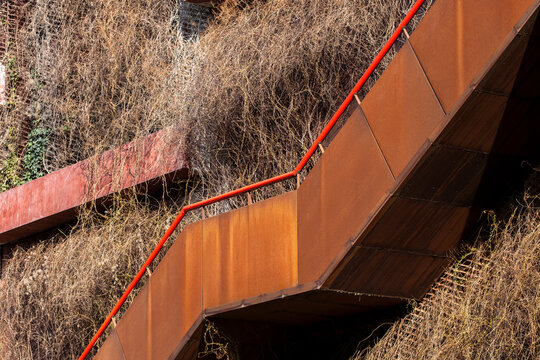 A concise architecture view showing a staircase moving through geometry along a compact structure supported by urban metal detail revealing modern symmetry shaped by coherent minimal design choices