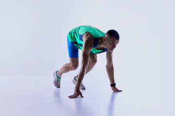 Runner leaning forward in sprint launch motion. Concept of sports ads, athlete motion studies,...