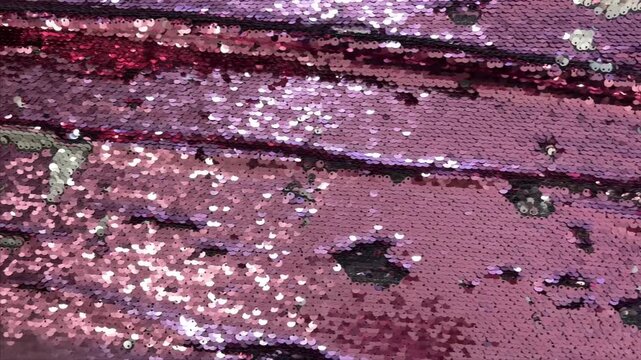 Bright pink sequins texture fabric, holiday background. 
