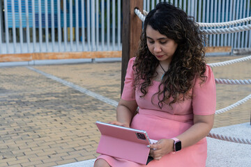 Woman working on tablet outdoors, digital lifestyle