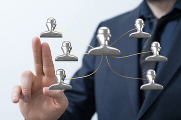 Business professional with hand gesture interacting with a virtual network of people representing connection and teamwork.