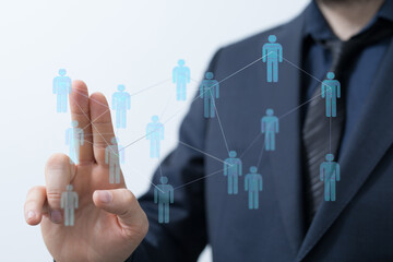 Close-up of a businessman's hand interacting with a digital network, representing concepts like teamwork, communication, and technological advan