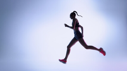 Futuristic female runner moving in dynamic silhouette across neon gradient background. Concept of sports tech visuals, performance coaching materials, and modern high-energy training content.