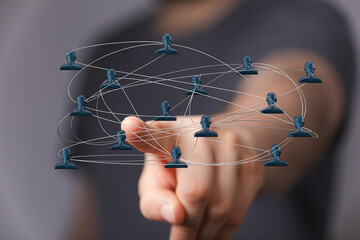 Concept of digital networking and teamwork with connected people icons on a blurred background, representing community collaboration