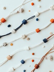Overhead shot of various necklaces with colorful beads and small stones arranged on a white background. Studio lighting.
