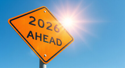 Naklejka premium An orange reflective road sign reading 2026 AHEAD is set against a bright blue sky, symbolizing the future, upcoming challenges, and the new year