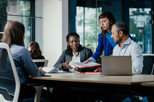 Meeting between Diverse Senior Management Team and Junior Officers in Modern Open Office Meeting