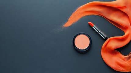 Makeup products including lipstick, blush, and orange fabric arranged on a dark surface.