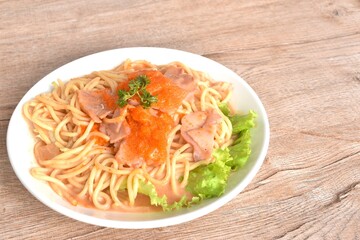 spicy stir fried spaghetti with slice ham pork dressing Rose Korean sauce topping shrimp egg on plate 
