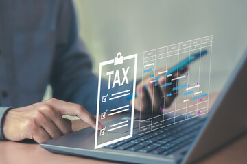 Tax return calculation concept financial research government tax businessman using laptop filling out income tax form online for payment	