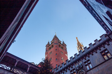Low angle view of the decorated Christmas tree and the historic red Town Hall (Rathaus) tower with a golden spire