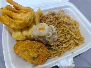 Mie Gacoan, Fried Noodles with Spicy Levels, is very popular in Indonesia, served with Fried Dumplings, sprinkled with chicken and other toppings, has a spicy taste and delights its fans.	