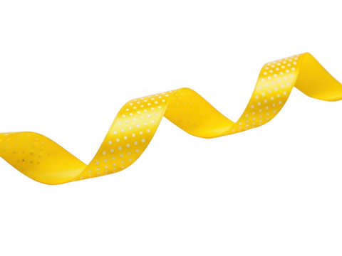 A bright yellow satin ribbon with small white polka dots, elegantly curled and isolated on transparent background for crafting or decoration purposes