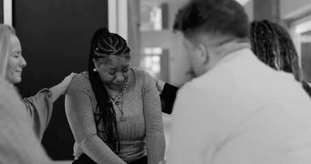Support group consoling crying woman during intense therapy session, holding hands and offering emotional reassurance in healing circle, black and white