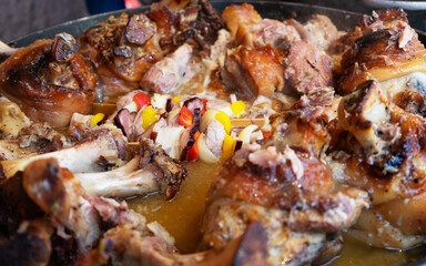 Large baked meat shanks cooking in thick broth.