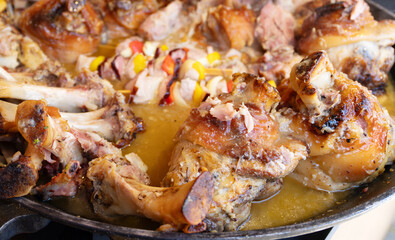 Large baked meat shanks cooking in thick broth.