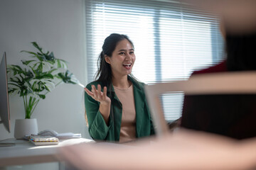 Asian businesswoman discussing with colleague in office meeting