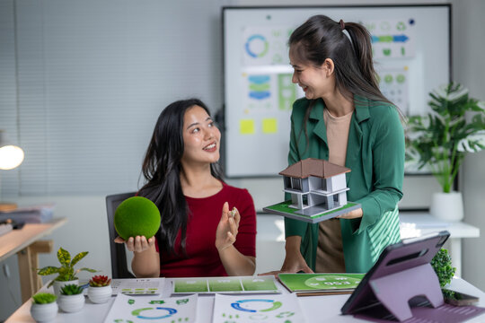 Asian women discussing green building and sustainable real estate