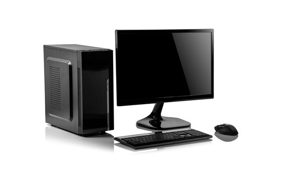 A black desktop computer setup, including a tower case, monitor, keyboard, and mouse, sits on a reflective white surface.