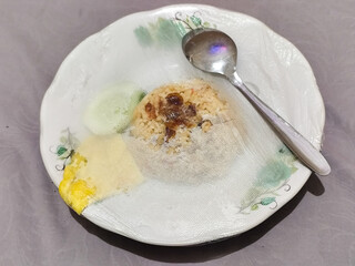 Fried rice in a plate covered with plastic.