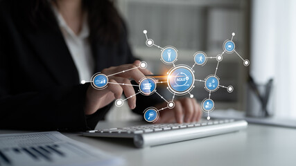 A business professional using a keyboard while analyzing data with digital visualization in a modern office. Ideal for themes of technology and analysis in professional settings. Tessel