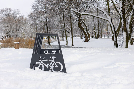 Bicycle parking rack in snowy city park during winter season