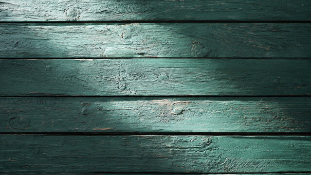 Weathered teal wooden planks form a textured background, showcasing distressed paint, natural grain, and visible knots under uneven lighting, creating a rustic, atmospheric surface.