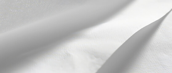 Fototapeta premium Close-up of clean white paper showing subtle texture and gentle creases. Ideal for minimal backgrounds or mockups