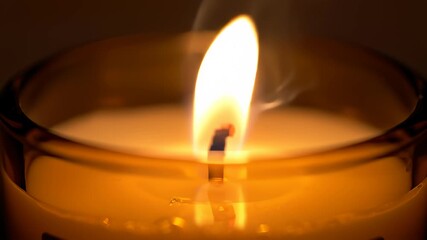 Candle Flame Flickering Gently in a Glass Holder With Smoke