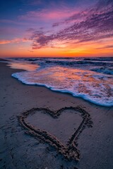 Heart Shape Drawn On Sandy Beach Shoreline During Golden Hour With Vibrant Sky And Gentle Waves
