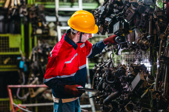 Technician Using Barcode Scanner and Tablet to Manage Auto Parts Inventory in Warehouse