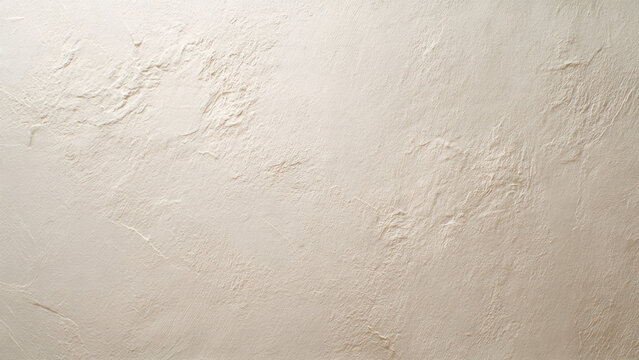 A light beige, off-white textured wall background featuring an irregular, rough surface with prominent stucco-like brush strokes and undulating patterns.