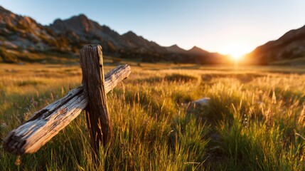 A rustic wooden cross stands elegantly in a lush green meadow, illuminated by the golden hues of a sunset, symbolizing peace and reflection in nature's beauty.