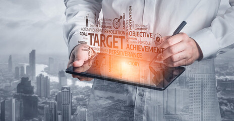 A business professional engages with a digital tablet, outlining goals and achievements against a modern city skyline, symbolizing ambition and strategic planning. Tessel